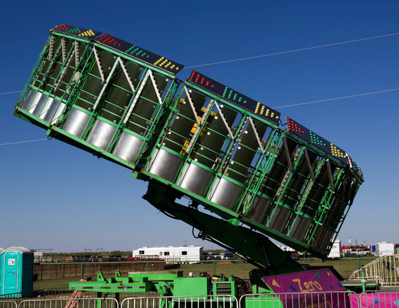 A carnival ride that is upside down and green.