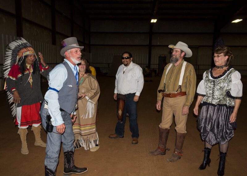 A group of people in costumes standing around.